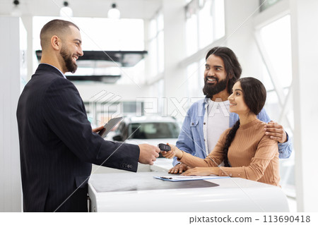 Young eastern couple buying a new car Young eastern couple buying a new car 113690418