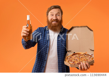 Redhaired bearded guy holding pizza box and beer bottle, studio Redhaired bearded guy holding pizza box and beer bottle, studio 113690444