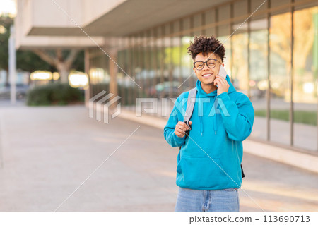 Student talking on phone in urban area Student talking on phone in urban area 113690713