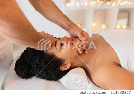Therapeutic face massage in a serene spa 113690837