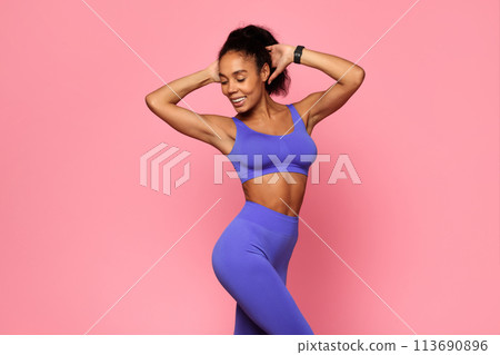 Happy woman dancing in blue sports outfit 113690896