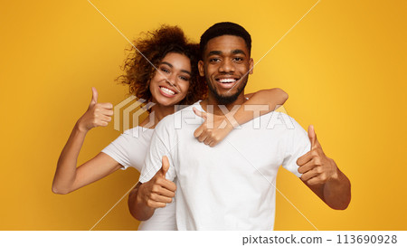 Cheerful african couple showing thumbs up gesture Cheerful african couple showing thumbs up gesture 113690928