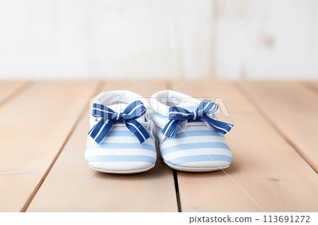 Newborn striped baby shoes on wooden background Newborn striped baby shoes on wooden background 113691272