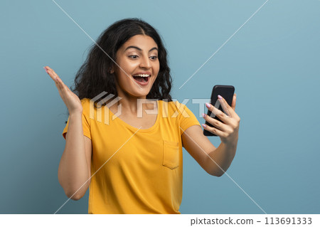 Joyous woman video calling on teal Joyous woman video calling on teal 113691333