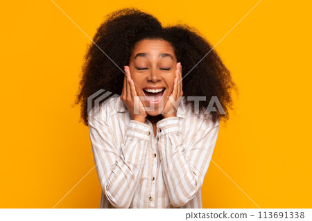 Excited young woman smiling on yellow background 113691338