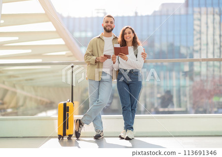 Happy Couple Walking With Suitcase and Passport at Airport Terminal 113691346