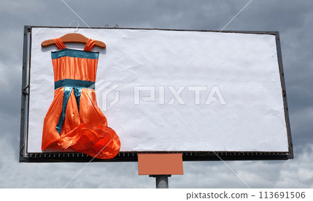 Kiev Ukraine June 5, 2021: a huge women's dress on an advertising billboard in the city of Kiev Kiev Ukraine June 5, 2021: a huge women's dress on an advertising billboard in the city of Kiev 113691506