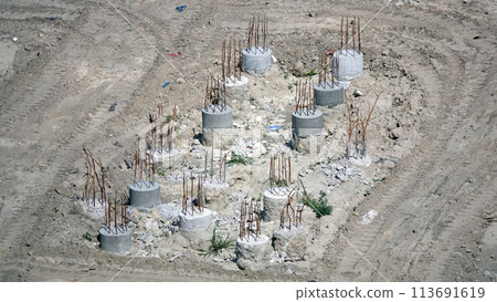 Kiev, Ukraine March 13, 2019: Foundation zero cycle construction, concrete piles at construction site Kiev, Ukraine March 13, 2019: Foundation zero cycle construction, concrete piles at construction site 113691619