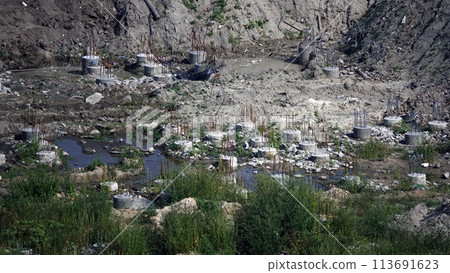 Kiev, Ukraine March 13, 2019: Foundation zero cycle construction, concrete piles at construction site Kiev, Ukraine March 13, 2019: Foundation zero cycle construction, concrete piles at construction site 113691623