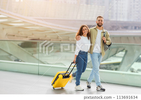 Time For Trip. Happy European Couple Walking With Luggage At Airport Terminal Time For Trip. Happy European Couple Walking With Luggage At Airport Terminal 113691634
