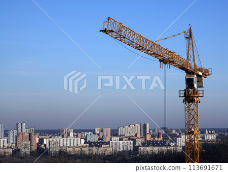 High construction cranes on the background of houses on the left bank of the city of Kiev 113691671