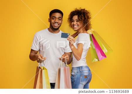 Young black couple with shopping bags and credit card 113691689