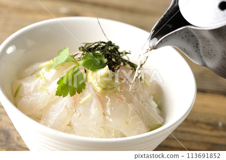Pouring dashi over sea bream chazuke topped with mitsuba, shredded nori seaweed, and wasabi Pouring dashi over sea bream chazuke topped with mitsuba, shredded nori seaweed, and wasabi 113691852