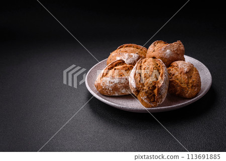 Fresh baked bread buns with salt, spices, seeds and grains Fresh baked bread buns with salt, spices, seeds and grains 113691885