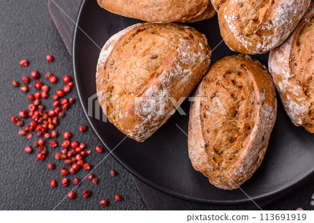 Fresh baked bread buns with salt, spices, seeds and grains 113691919