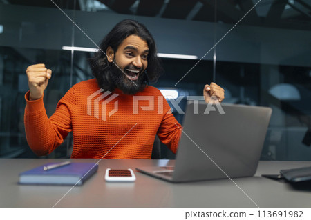 Man excited with computer in office 113691982