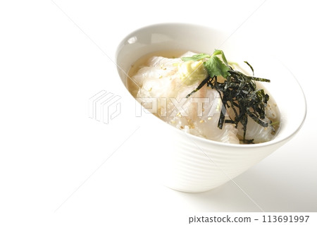 Sea bream chazuke topped with mitsuba, shredded seaweed, and wasabi photographed on a white background Sea bream chazuke topped with mitsuba, shredded seaweed, and wasabi photographed on a white background 113691997