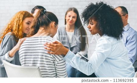 Addicted people comforting woman at psychotherapy session Addicted people comforting woman at psychotherapy session 113692395