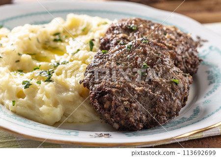 Minced meat cutlets with mashed potatoes topped with clarified butter. Traditional Slovak meatballs - Fasirky with potato puree. Minced meat cutlets with mashed potatoes topped with clarified butter. Traditional Slovak meatballs - Fasirky with potato puree. 113692699