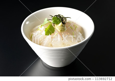 Sea bream chazuke with mitsuba, shredded seaweed, and wasabi, photographed against a black background before adding the dashi broth Sea bream chazuke with mitsuba, shredded seaweed, and wasabi, photographed against a black background before adding the dashi broth 113692712