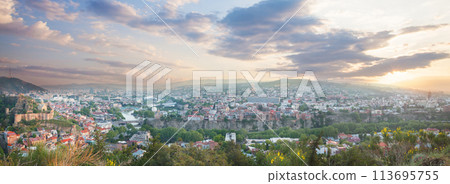 Panoramic beautiful landscape of historical Tbilisi with mountains and blue cloudy sky Panoramic beautiful landscape of historical Tbilisi with mountains and blue cloudy sky 113695755