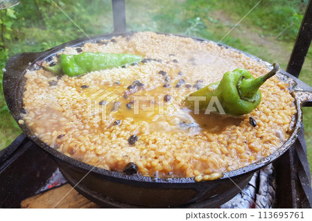 Freshly cooked pilaf in a big metal cauldron 113695761