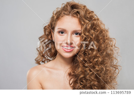 Glorious woman face. Young model with healthy skin, long hair and makeup on white background 113695789