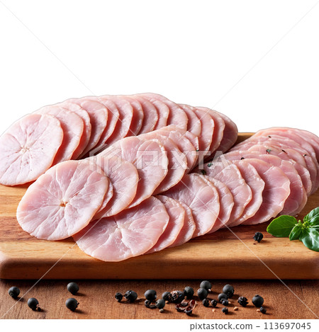 Mortadella thinly sliced and draped over a wooden serving board with a few cornichons and 113697045