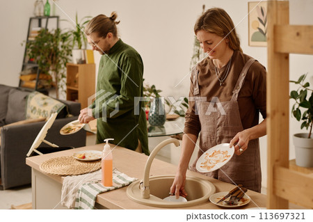 Putting dishes in sink after eating Putting dishes in sink after eating 113697321