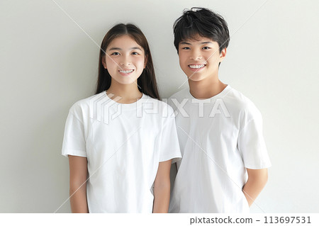 Portrait of z generation men and women wearing white t-shirts and smiling 113697531
