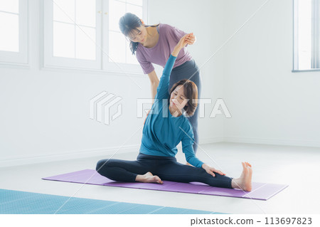 Woman practicing yoga in a yoga studio Woman practicing yoga in a yoga studio 113697823