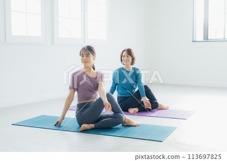 Woman practicing yoga in a yoga studio Woman practicing yoga in a yoga studio 113697825