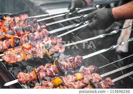 Cooking Caucasian barbecue (kebab, shashlik) on the grill Cooking Caucasian barbecue (kebab, shashlik) on the grill 113698298