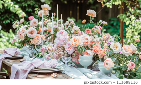 Table setting with rose flowers and candles for an event party or wedding reception in summer garden. 113699116