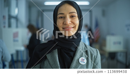 Portrait of Arabic woman looking at camera in polling station Portrait of Arabic woman looking at camera in polling station 113699438