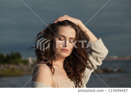 Beautiful brunette woman with fresh skin, natural make-up and healthy wavy brown hair Beautiful brunette woman with fresh skin, natural make-up and healthy wavy brown hair 113699487