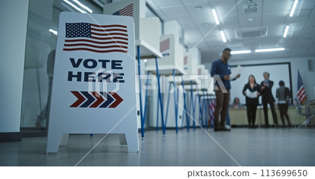 Vote here sign on the floor in polling station office 113699650