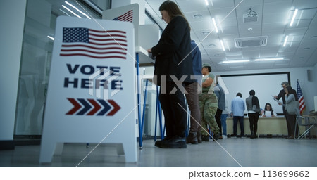 Vote here sign on the floor in polling station office 113699662