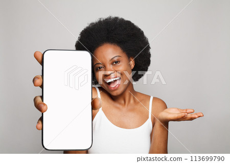 Excited healthy woman holding smartphone with white empty blank screen display Excited healthy woman holding smartphone with white empty blank screen display 113699790