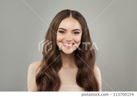 Cute young happy woman model with natural make-up, clean healthy fresh skin and long hair posing 113700154