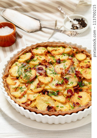 Irish potato pie with bacon in baking dish 113700215