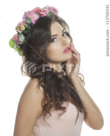 Cheerful brunette woman with fresh flower on her head. Spring, cosmetic, beauty 113700342