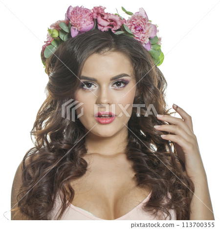 Portrait of healthy woman with clean fresh skin, wavy long hair and flower wreath 113700355