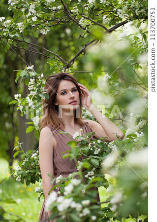 Charming spring woman enjoying nature outdoor, fashion beauty portrait 113700751