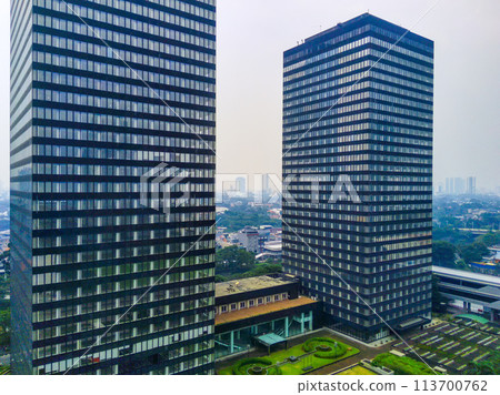 A view of two skyscrapers on Sudirman Street, Jakarta. The skyscrapers have many windows. A view of two skyscrapers on Sudirman Street, Jakarta. The skyscrapers have many windows. 113700762