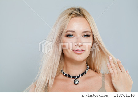 Lovely young blonde lady with fresh clear skin and long smooth straight hairstile  113701116