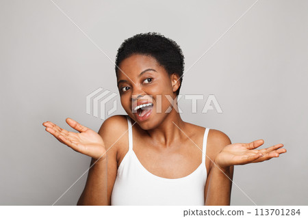 Perfect happy young woman holding empty blank hand palm. Advertising, product placement, 113701284