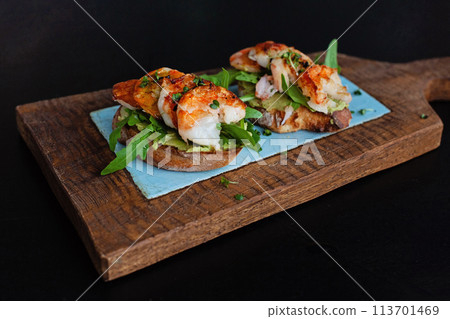 Healthy appetizer or snack shrimp bruschetta with whole grain bread on wooden board Healthy appetizer or snack shrimp bruschetta with whole grain bread on wooden board 113701469
