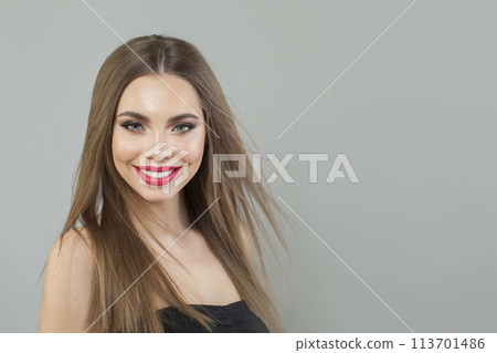 Attractive young brunette female model with long brown wavy hair and makeup closeup portrait 113701486