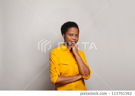 Young clever thinking African American woman standing on white background Young clever thinking African American woman standing on white background 113701562